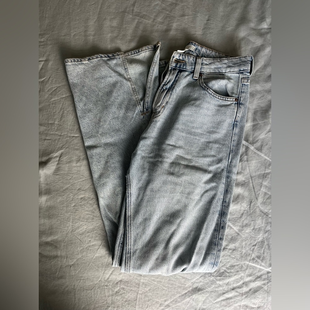 Light wash flare jeans with slit on ankles